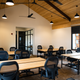 Brown desks and white tables in a room.